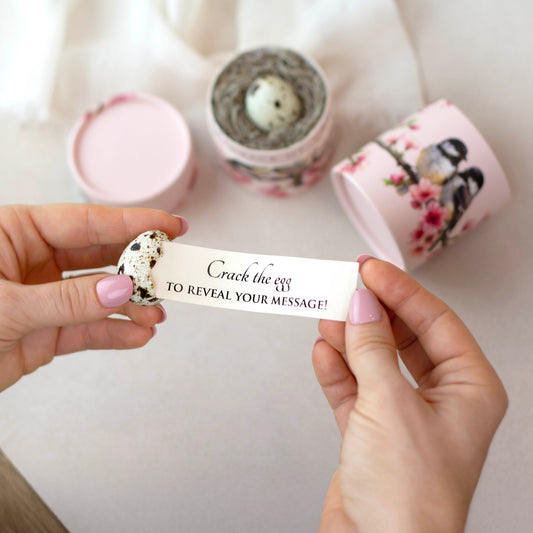 Person holding a card with text over a white background with decorative candles.