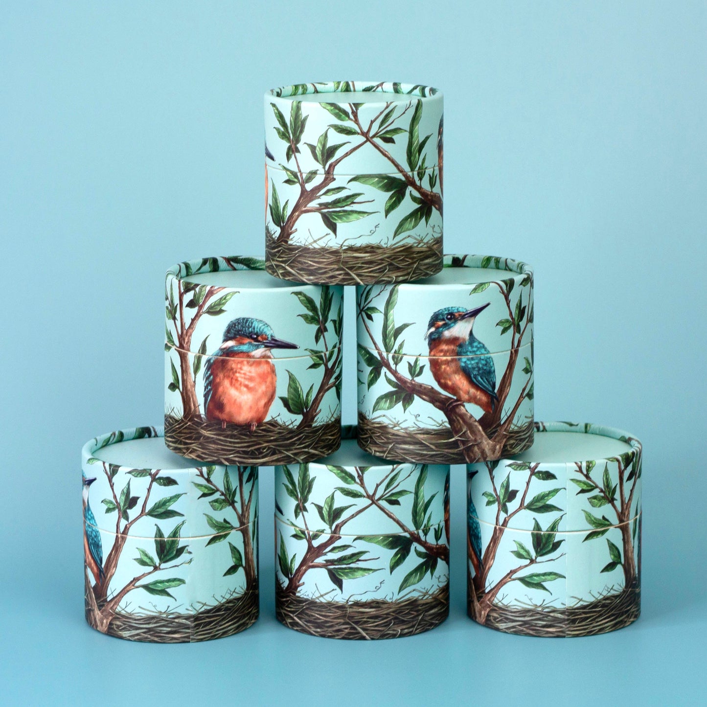 Stack of decorative kingfisher bird boxes on a blue background