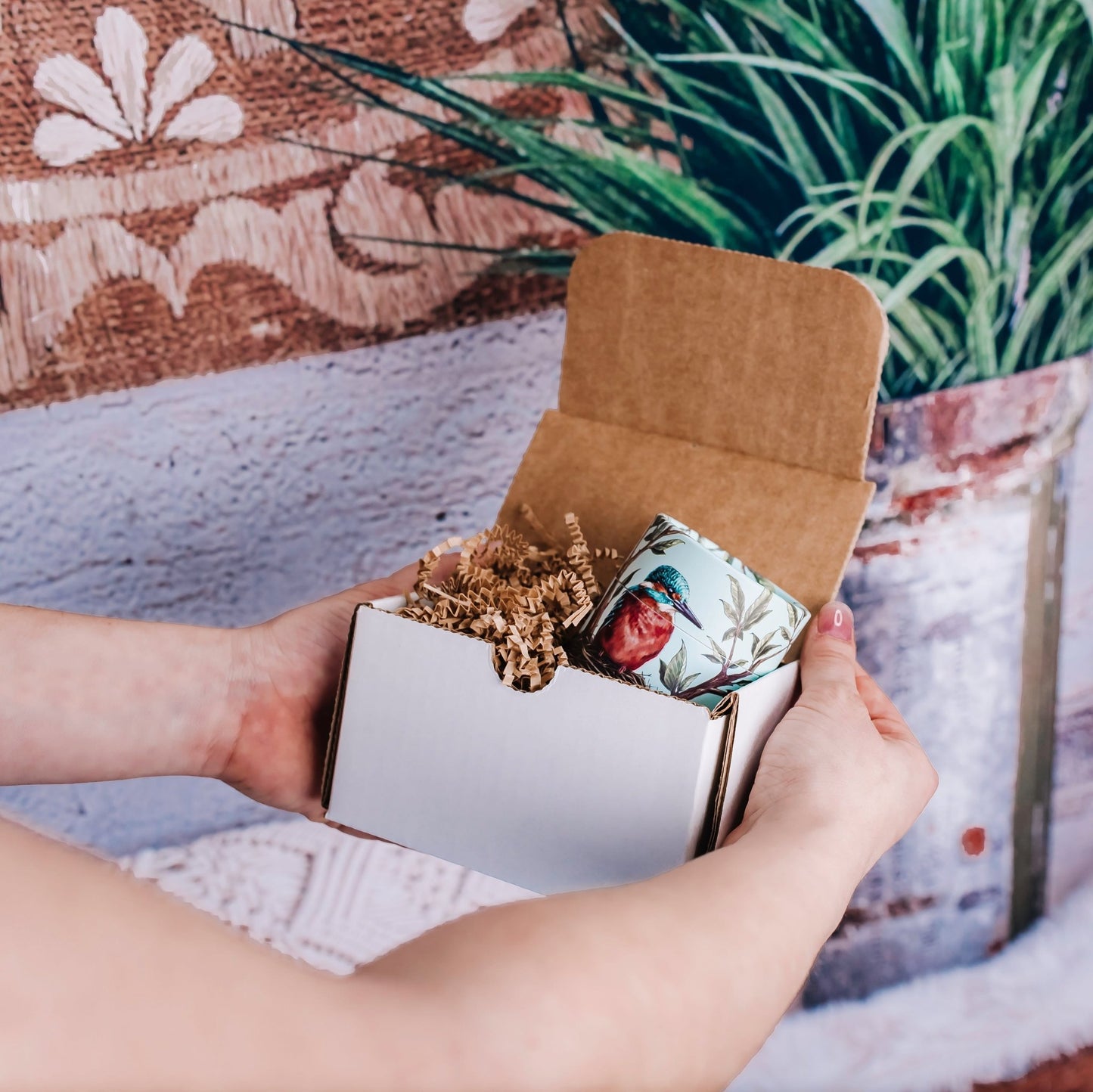 Kingfisher gift box inside of a postal mailer box with crinkle paper surrounding it.
