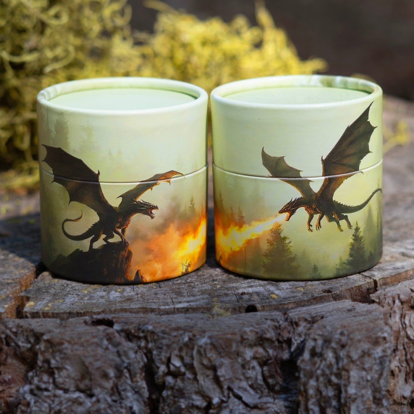 Two cylindrical containers with dragon designs on a wooden surface