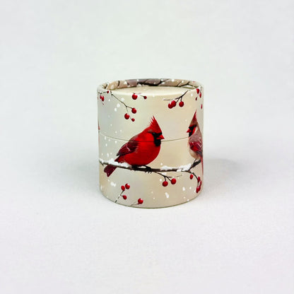 A small cylindrical gift box with cardinals on it rotates in stop motion. The lid pops off exposing the words "crack me" and a small red egg.  The egg hops out of the nest and cracks into pieces with a custom note inside. 