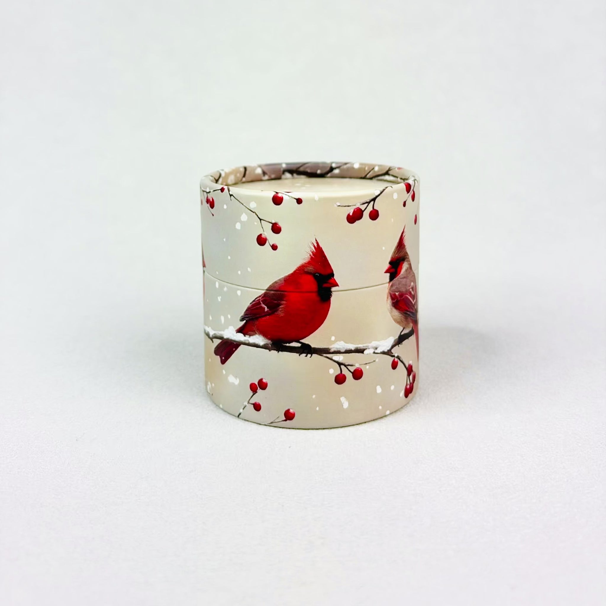A small cylindrical gift box with cardinals on it rotates in stop motion. The lid pops off exposing the words "crack me" and a small red egg.  The egg hops out of the nest and cracks into pieces with a custom note inside. 